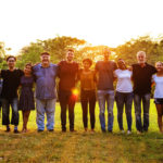 background image of a group of people in a meadow